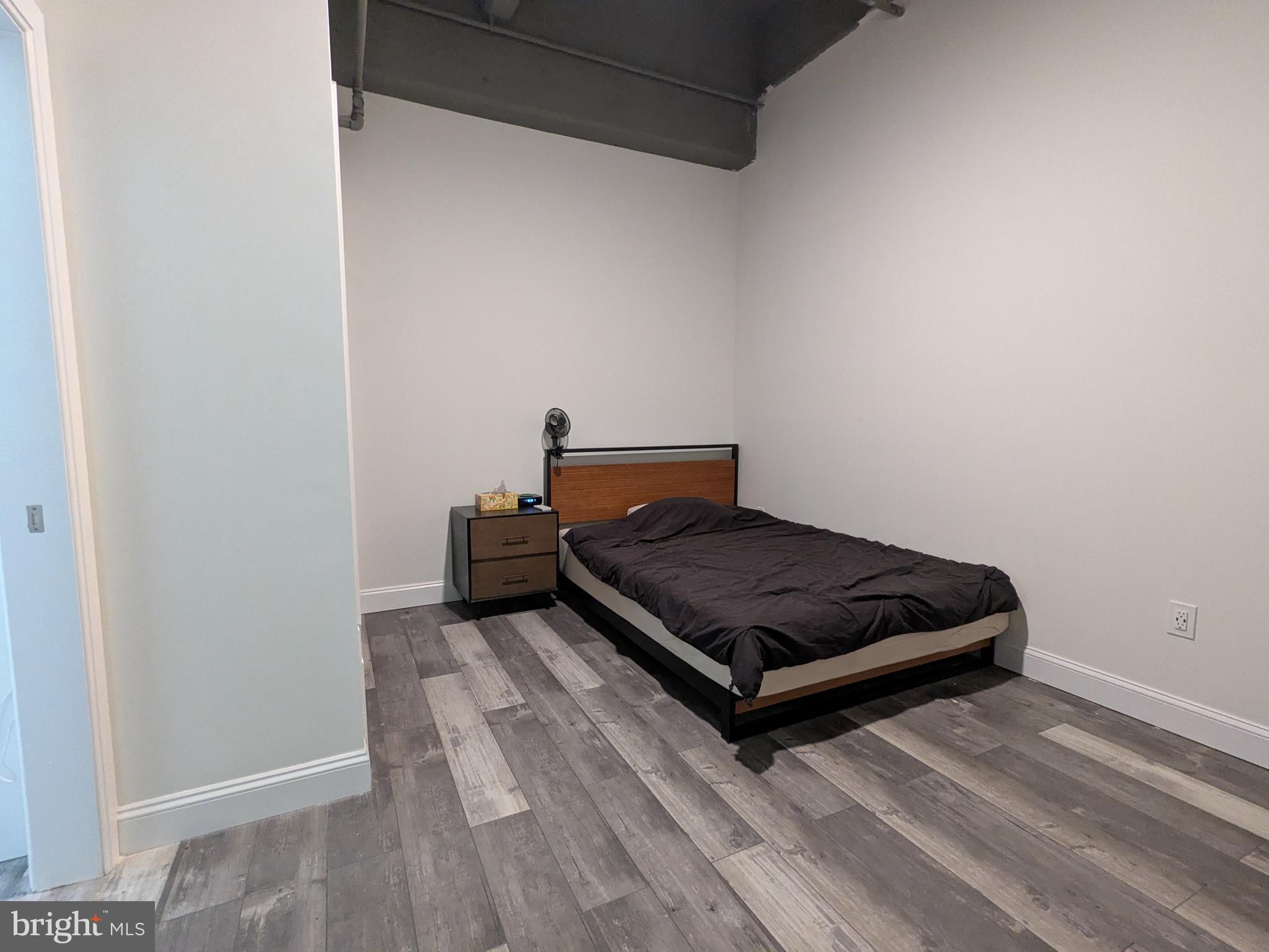 511 North Broad Street, Unit 204 Philadelphia, PA 19123 - Photo 10 of 47 a bedroom with a bed and wooden floor