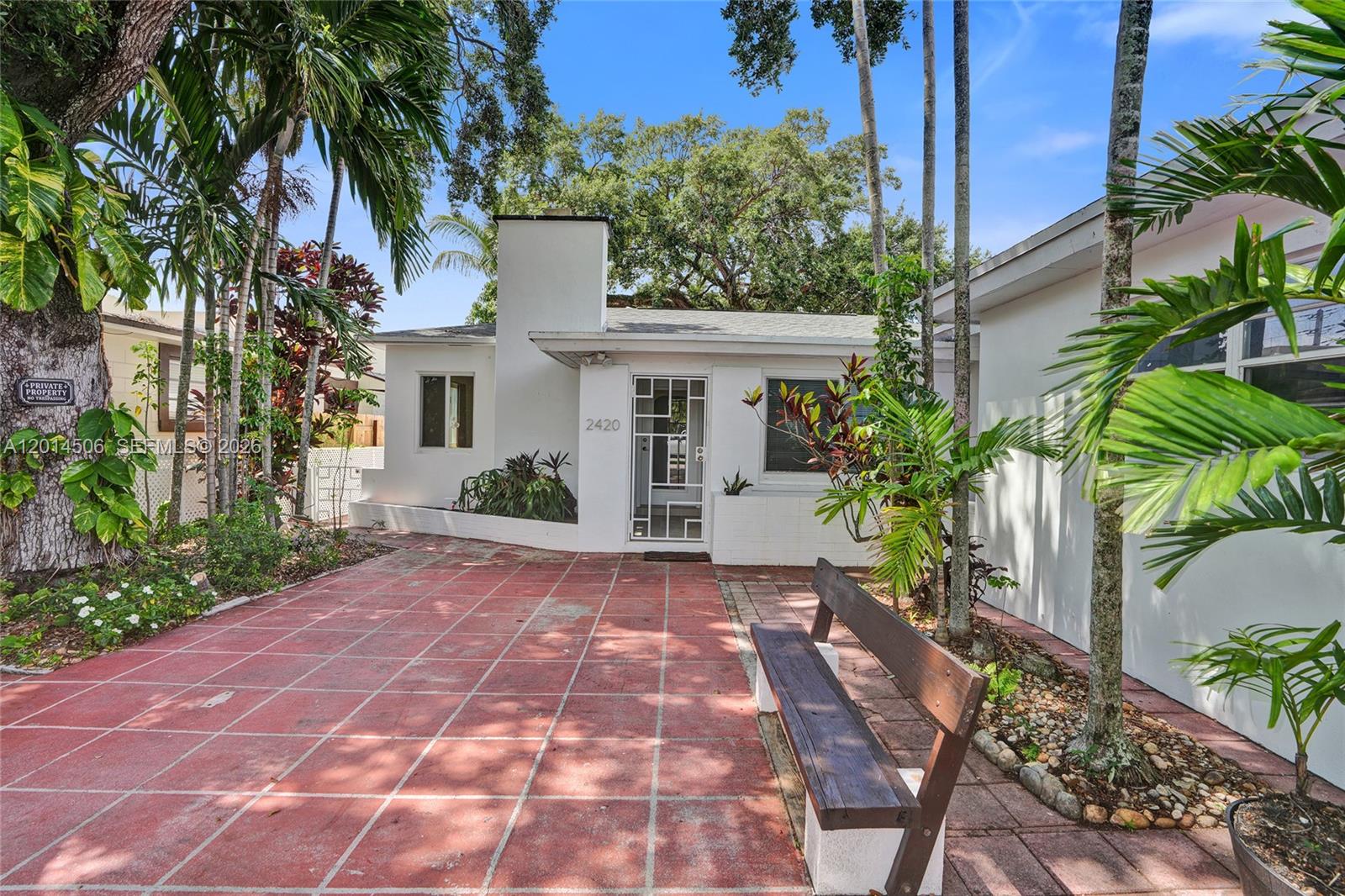 2420 Southwest 16th Street Miami, FL 33145 - Photo 1 of 35 a view of a white house with a yard and plants