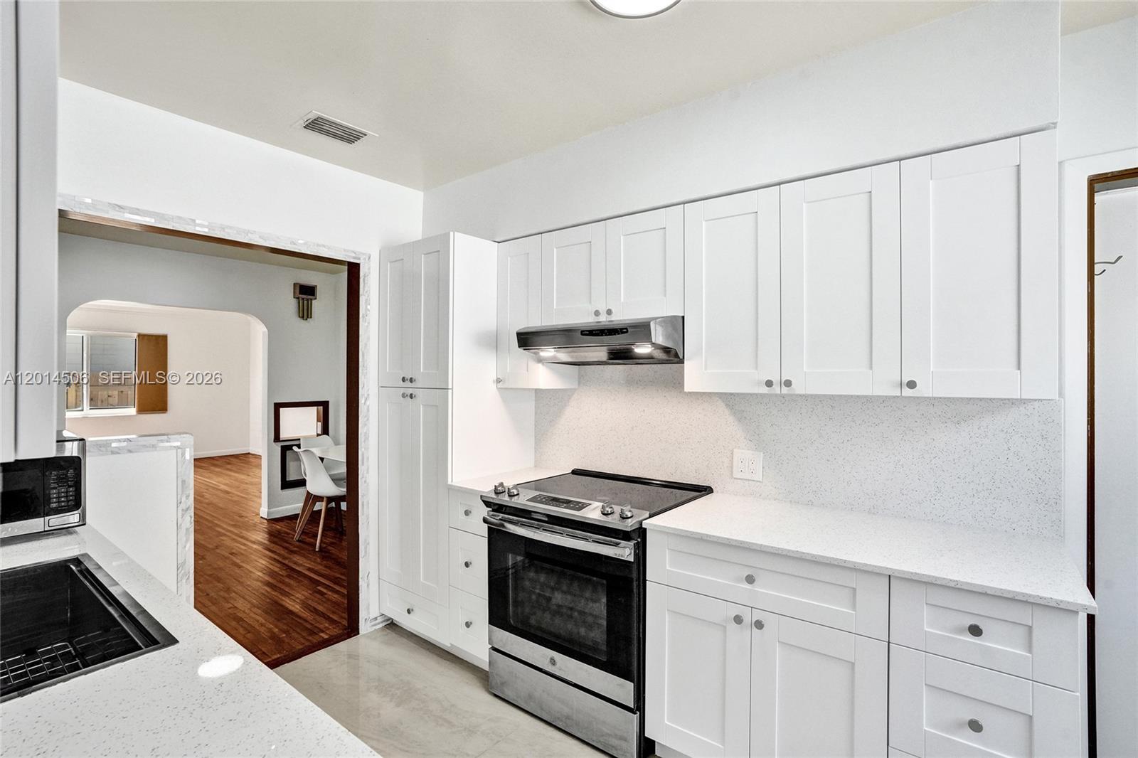2420 Southwest 16th Street Miami, FL 33145 - Photo 12 of 35 a kitchen with white cabinets and appliances