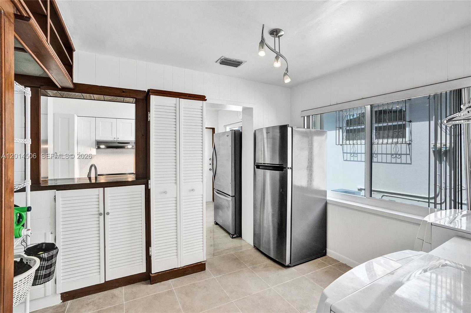2420 Southwest 16th Street Miami, FL 33145 - Photo 14 of 35 a view of a refrigerator and wooden floor in a room