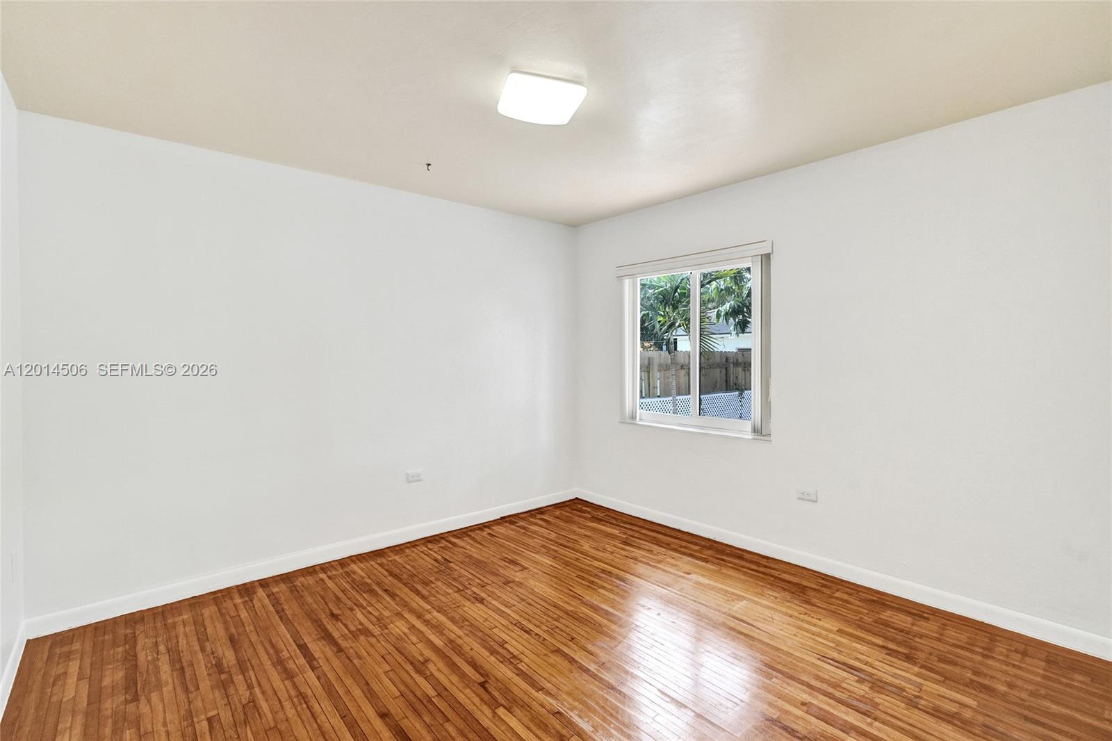 2420 Southwest 16th Street Miami, FL 33145 - Photo 16 of 35 an empty room with wooden floor and windows