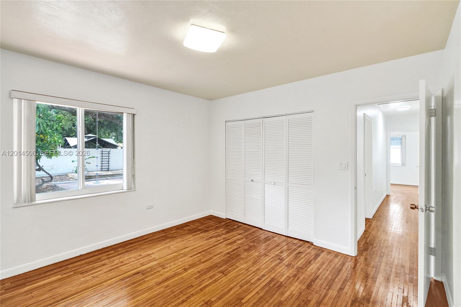 2420 Southwest 16th Street Miami, FL 33145 - Photo 17 of 35 a view of empty room with wooden floor and fan