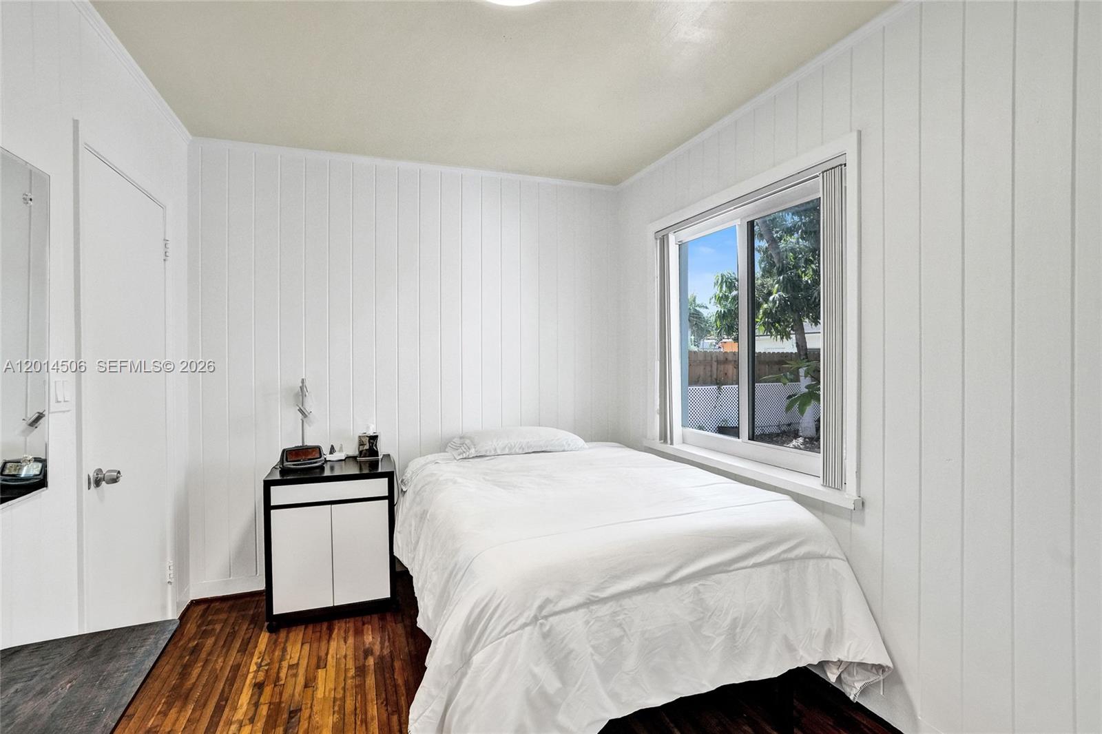 2420 Southwest 16th Street Miami, FL 33145 - Photo 19 of 35 a bedroom with a bed and a window