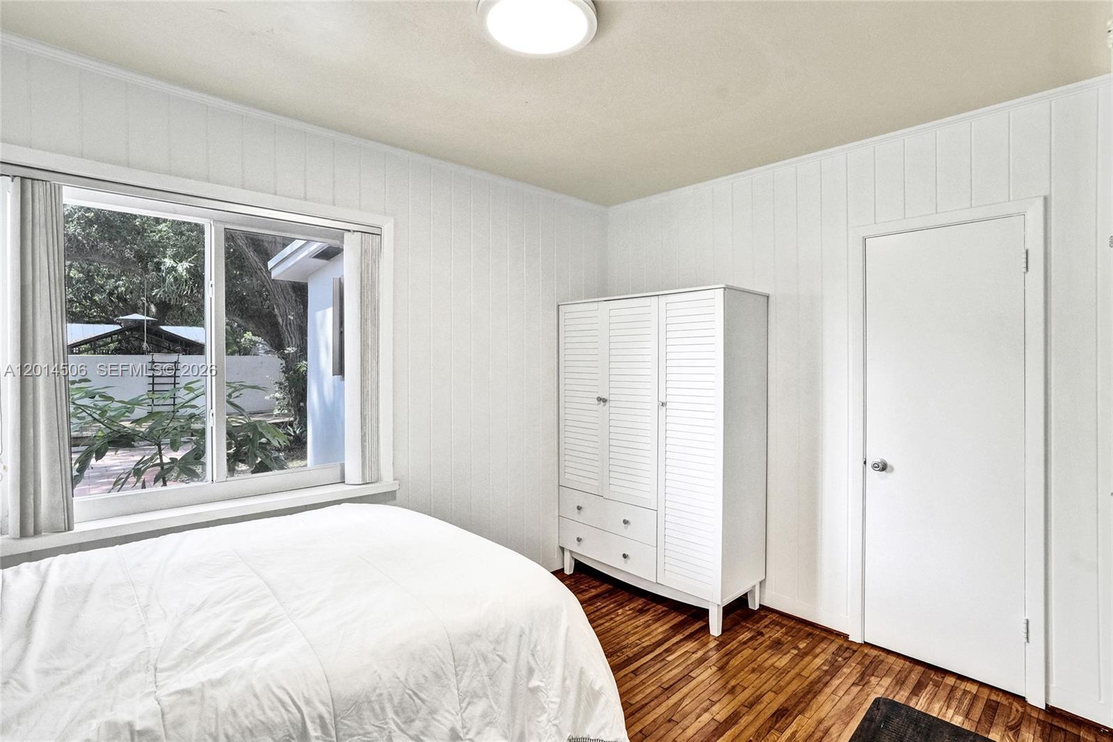 2420 Southwest 16th Street Miami, FL 33145 - Photo 20 of 35 a bedroom with a bed and a window