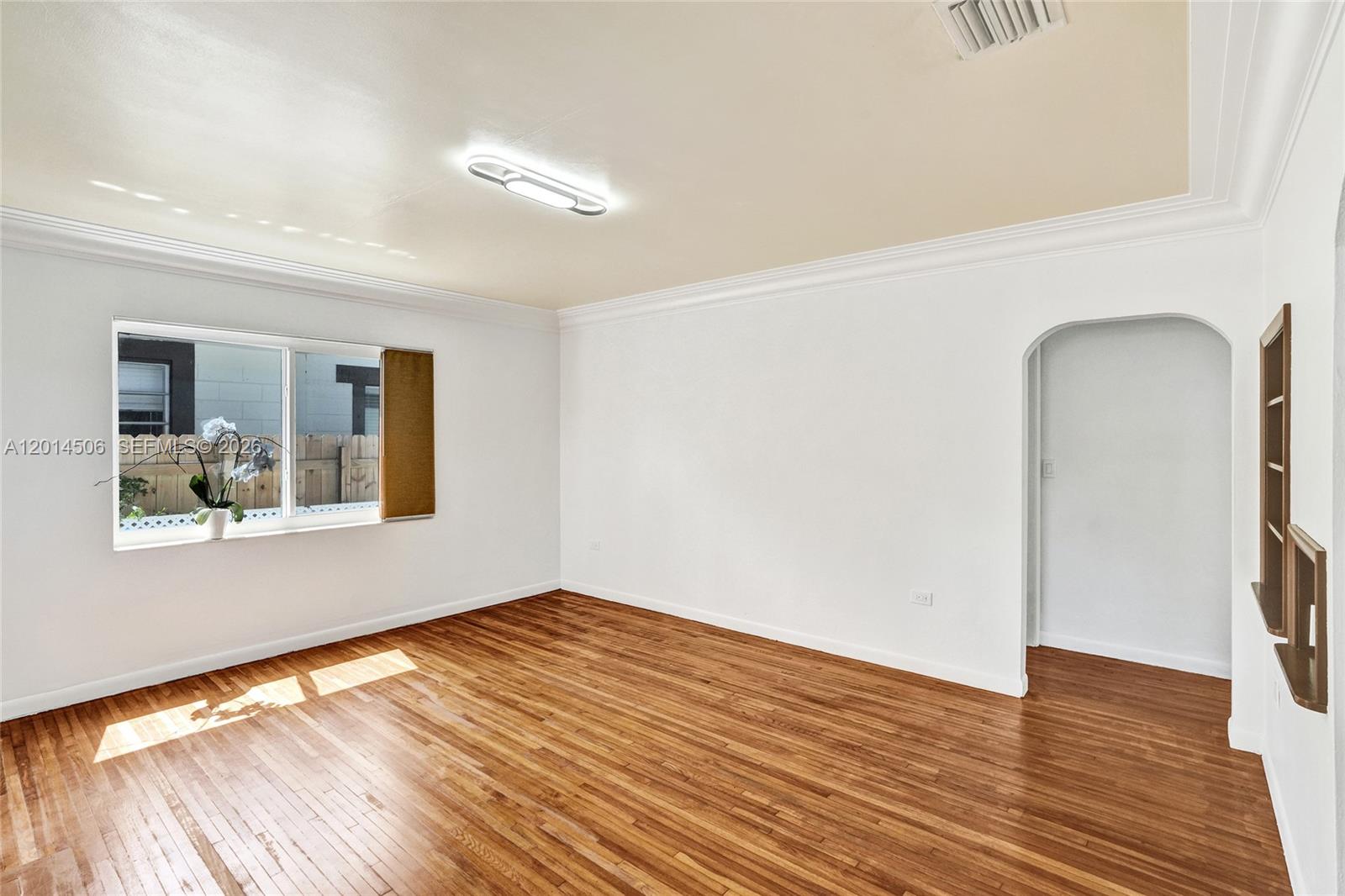 2420 Southwest 16th Street Miami, FL 33145 - Photo 2 of 35 a view of empty room with wooden floor and fan