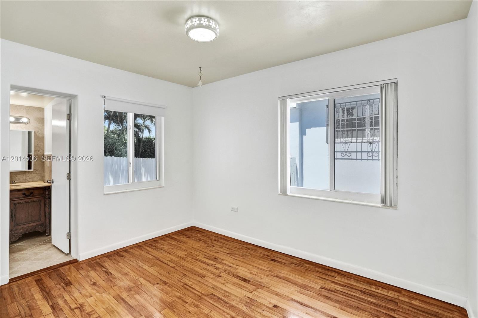 2420 Southwest 16th Street Miami, FL 33145 - Photo 23 of 35 an empty room with wooden floor and windows