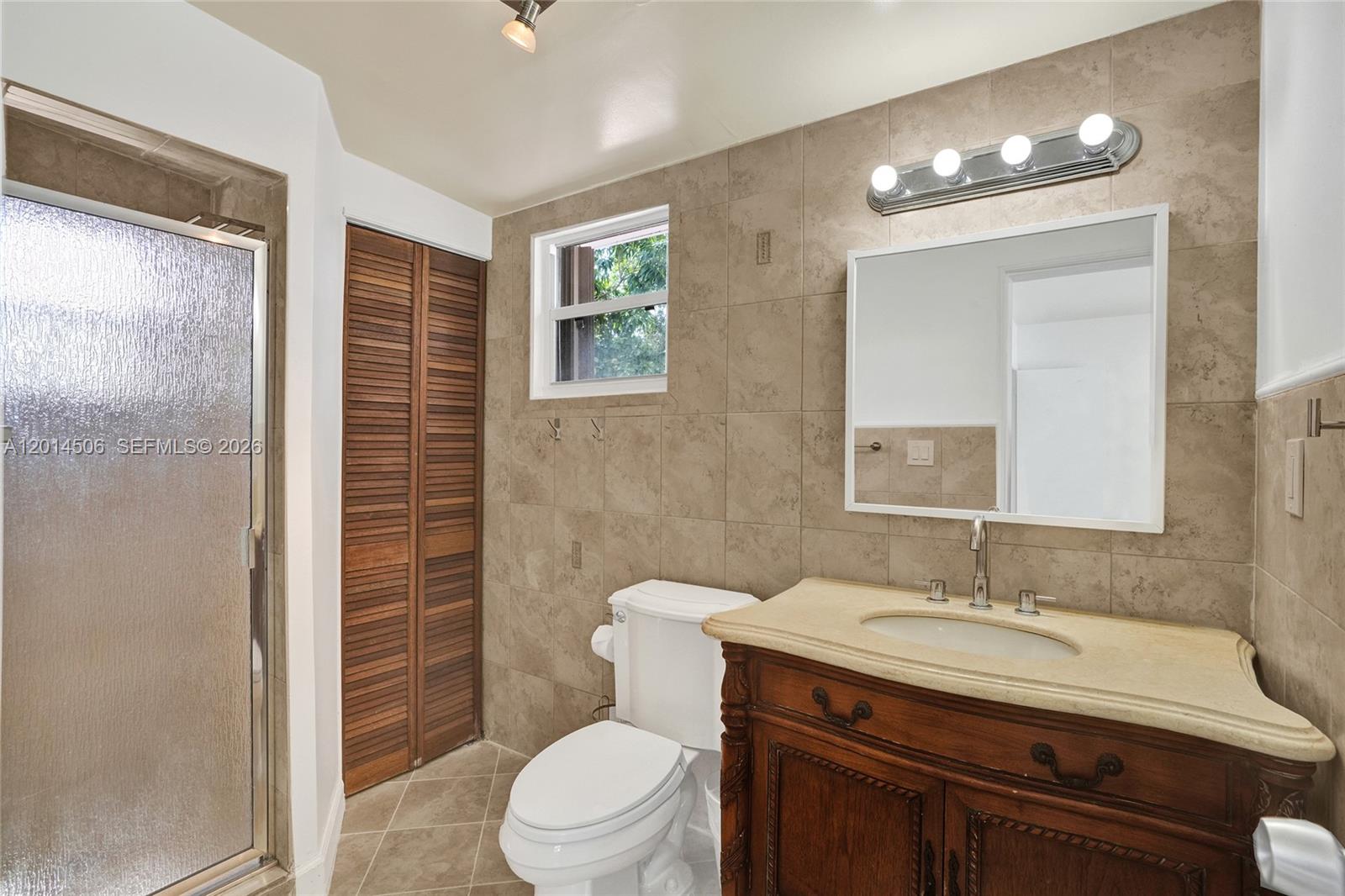 2420 Southwest 16th Street Miami, FL 33145 - Photo 27 of 35 a bathroom with a granite countertop sink toilet and shower