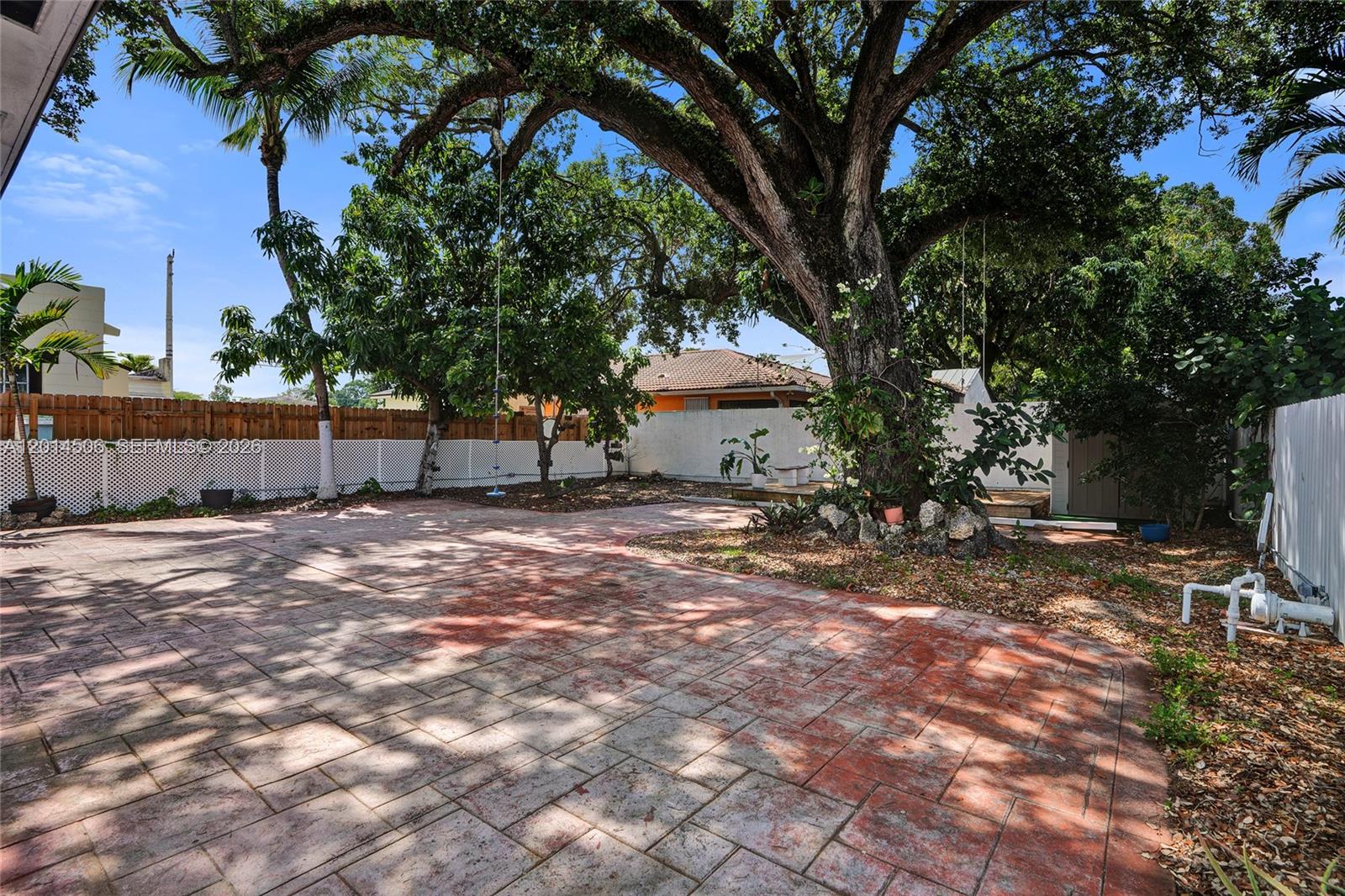2420 Southwest 16th Street Miami, FL 33145 - Photo 28 of 35 a backyard of a house with table and chairs