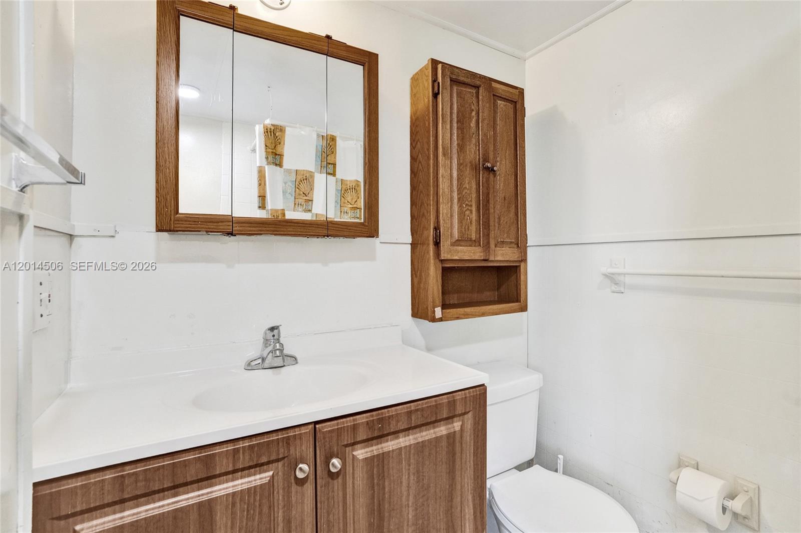 2420 Southwest 16th Street Miami, FL 33145 - Photo 35 of 35 a bathroom with a toilet a sink and mirror