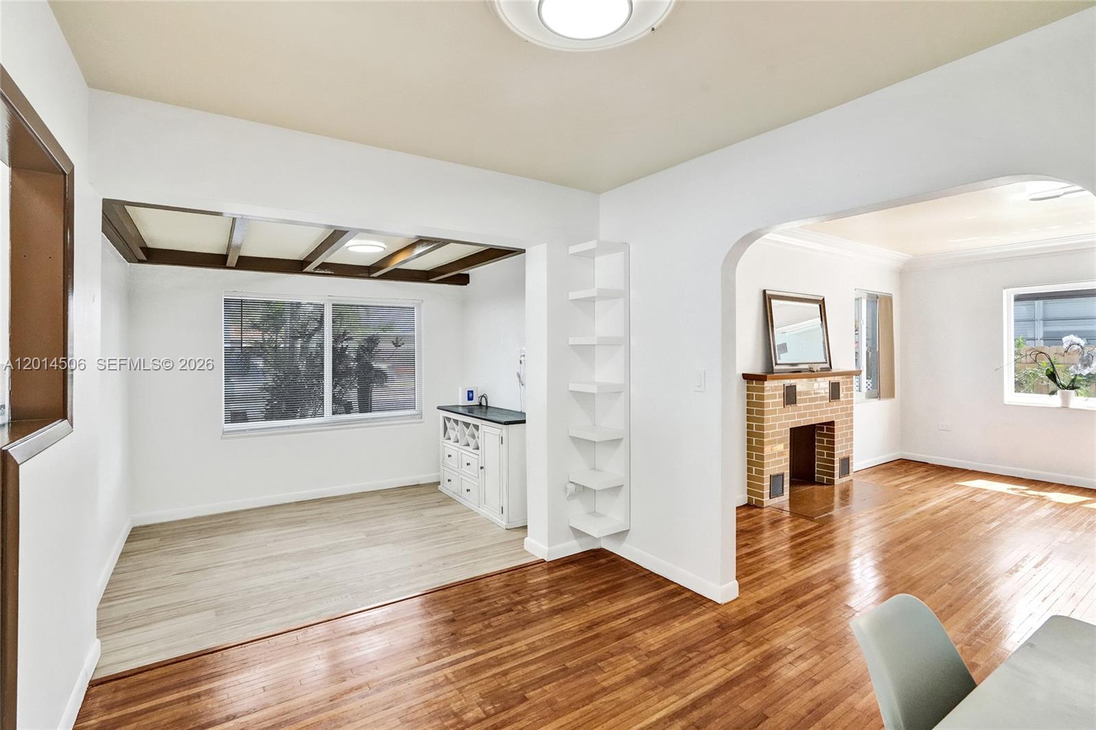 2420 Southwest 16th Street Miami, FL 33145 - Photo 6 of 35 a view of a livingroom with wooden floor and a kitchen space