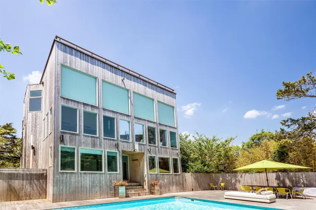 a view of house with outdoor space and swimming pool