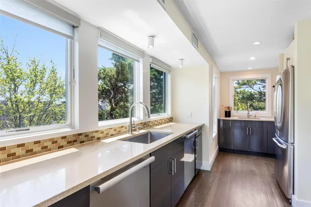 a kitchen with a sink and large window