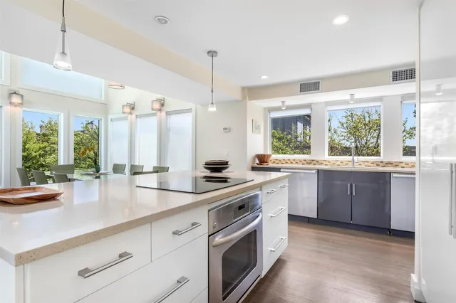 a kitchen with a sink stove and cabinets