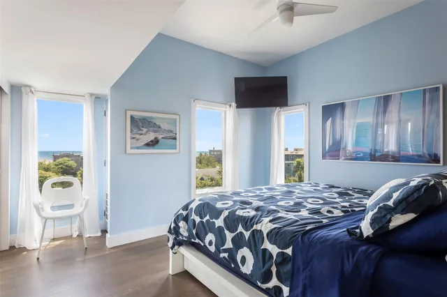 a bedroom with a bed and painting on the wall