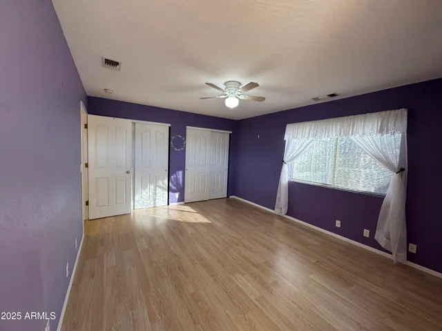a bathroom with a double vanity sink toilet and a mirror