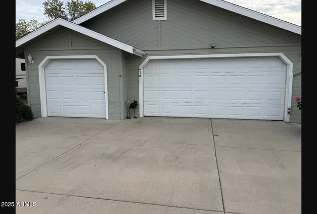 a backyard of a house with large window and brick wall