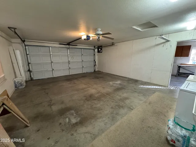 a kitchen with stainless steel appliances a stove a refrigerator a sink a stove with wooden floor