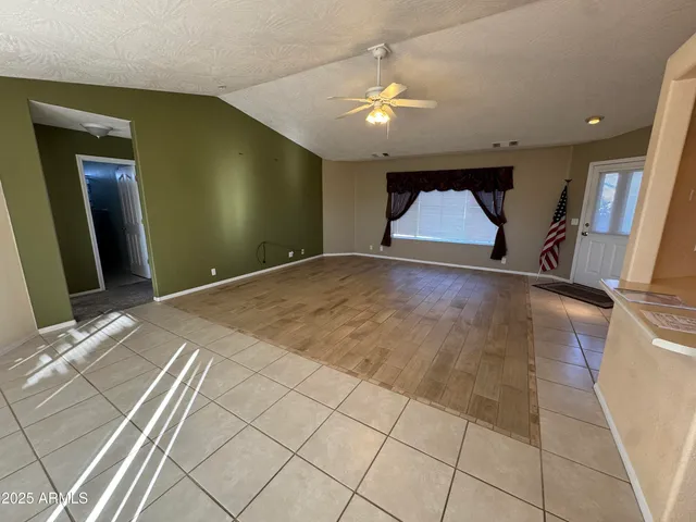 a view of hallway with a couch and a view of living room