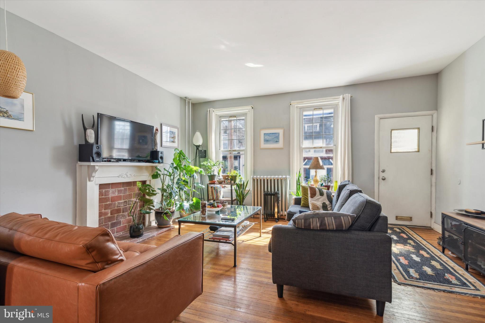 123 Kalos Street Philadelphia, PA 19128 - Photo 3 of 15 a living room with furniture a fireplace and a flat screen tv