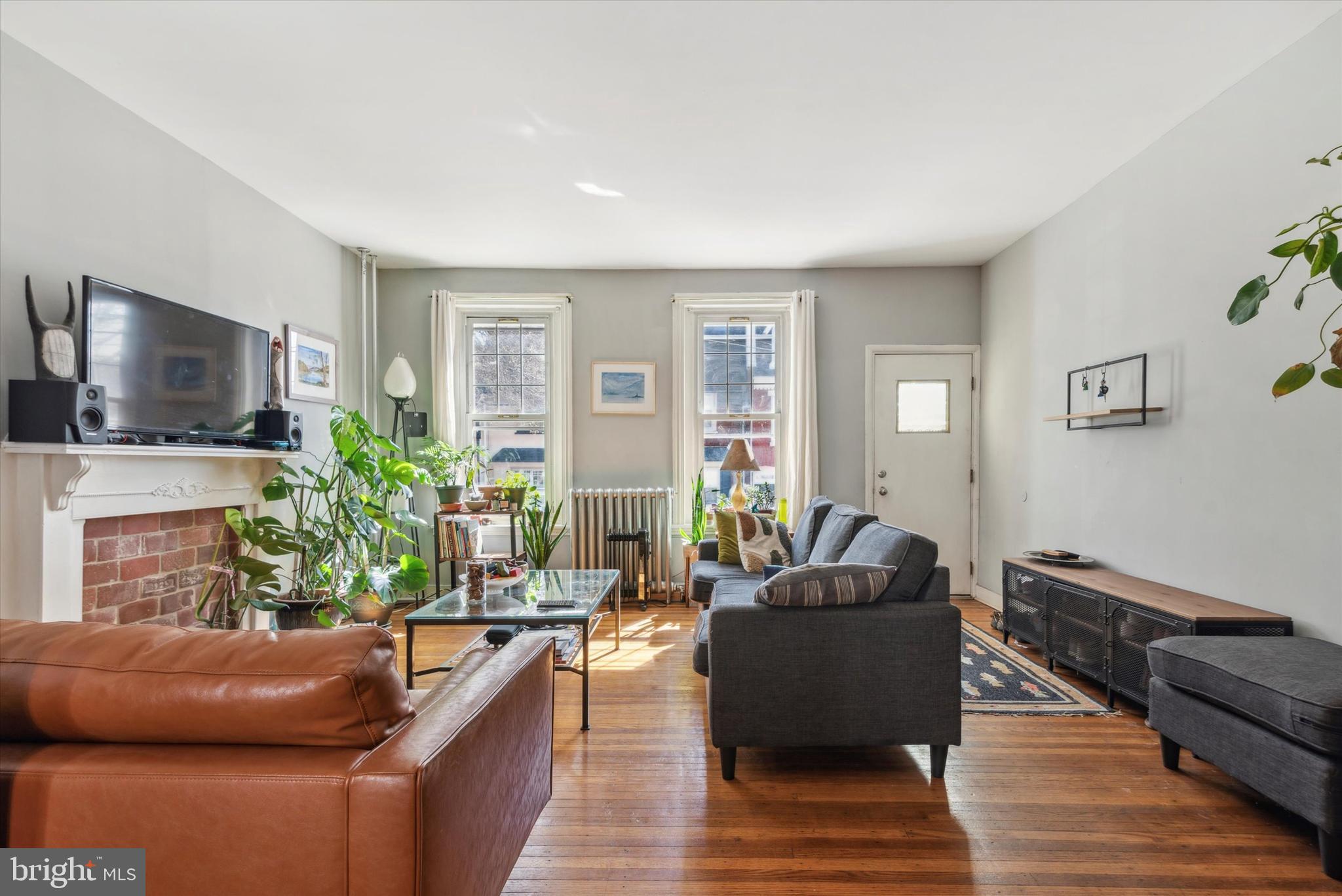 123 Kalos Street Philadelphia, PA 19128 - Photo 4 of 15 a living room with furniture a flat screen tv and a fireplace