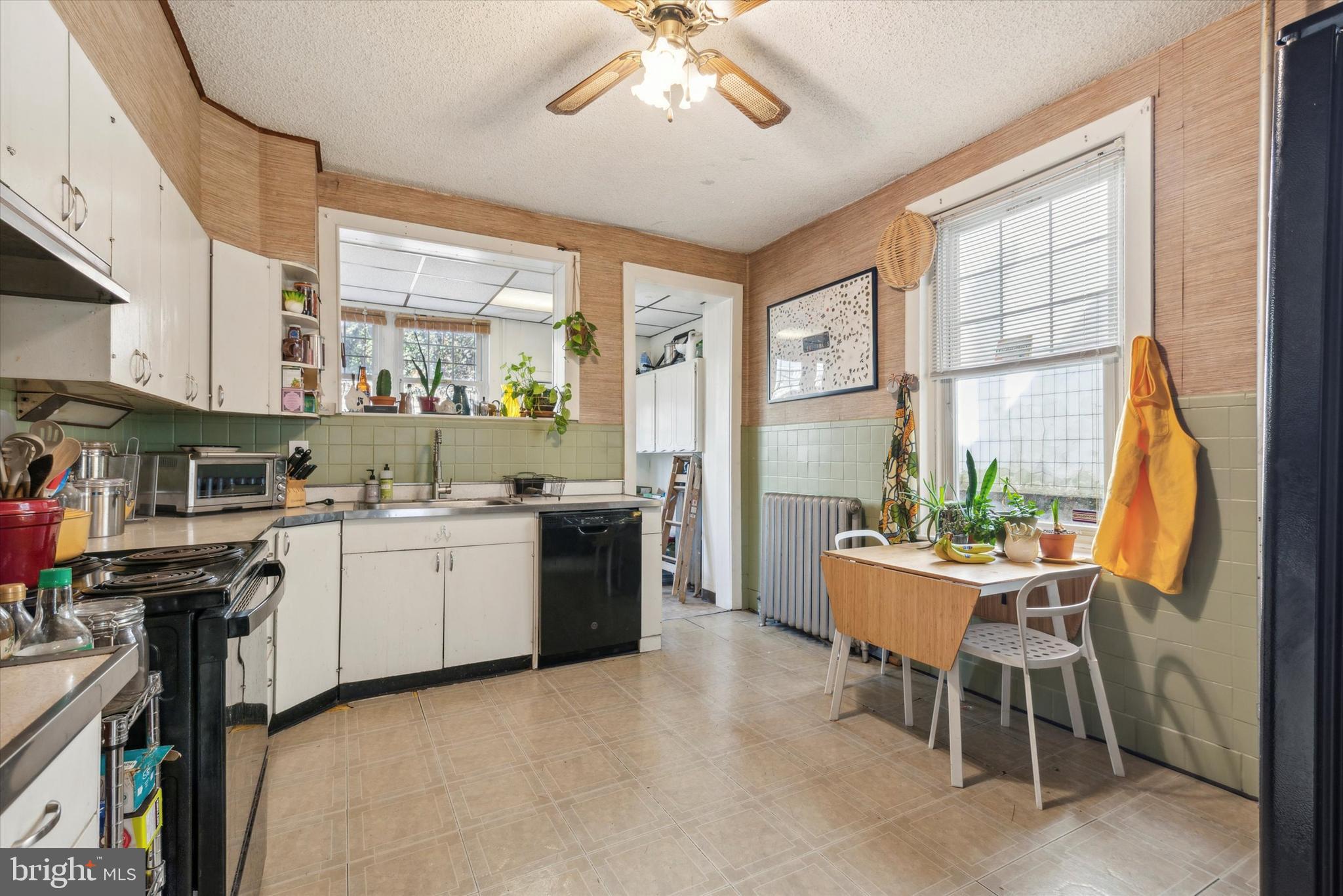 123 Kalos Street Philadelphia, PA 19128 - Photo 7 of 15 a kitchen with a table chairs stove and cabinets