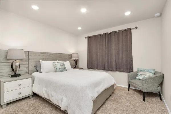 a bedroom with a bed and a couch