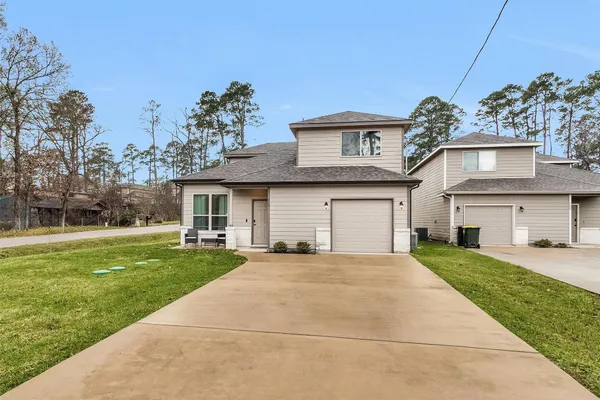 a front view of a house with a garden