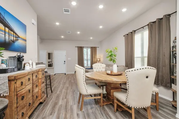 a view of a dining room with furniture window and wooden floor