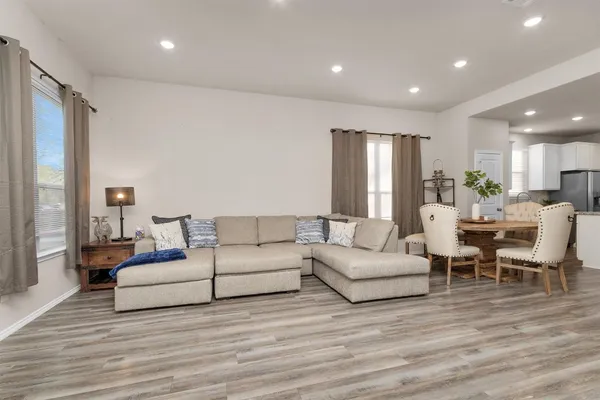 a living room with furniture and wooden floor