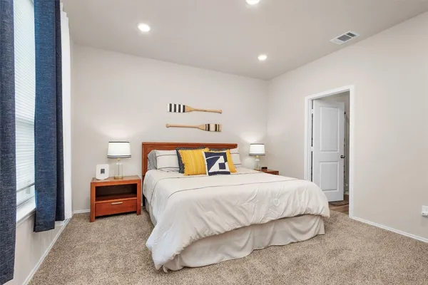 a bedroom with a bed and a night stand