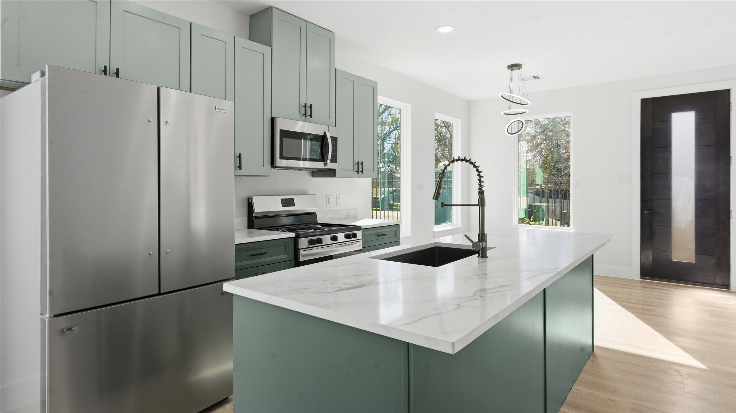 1317 Knight Street, Unit 1 Houston, TX 77022 - Photo 6 of 11 a kitchen with stainless steel appliances a refrigerator a sink a stove a table and chairs