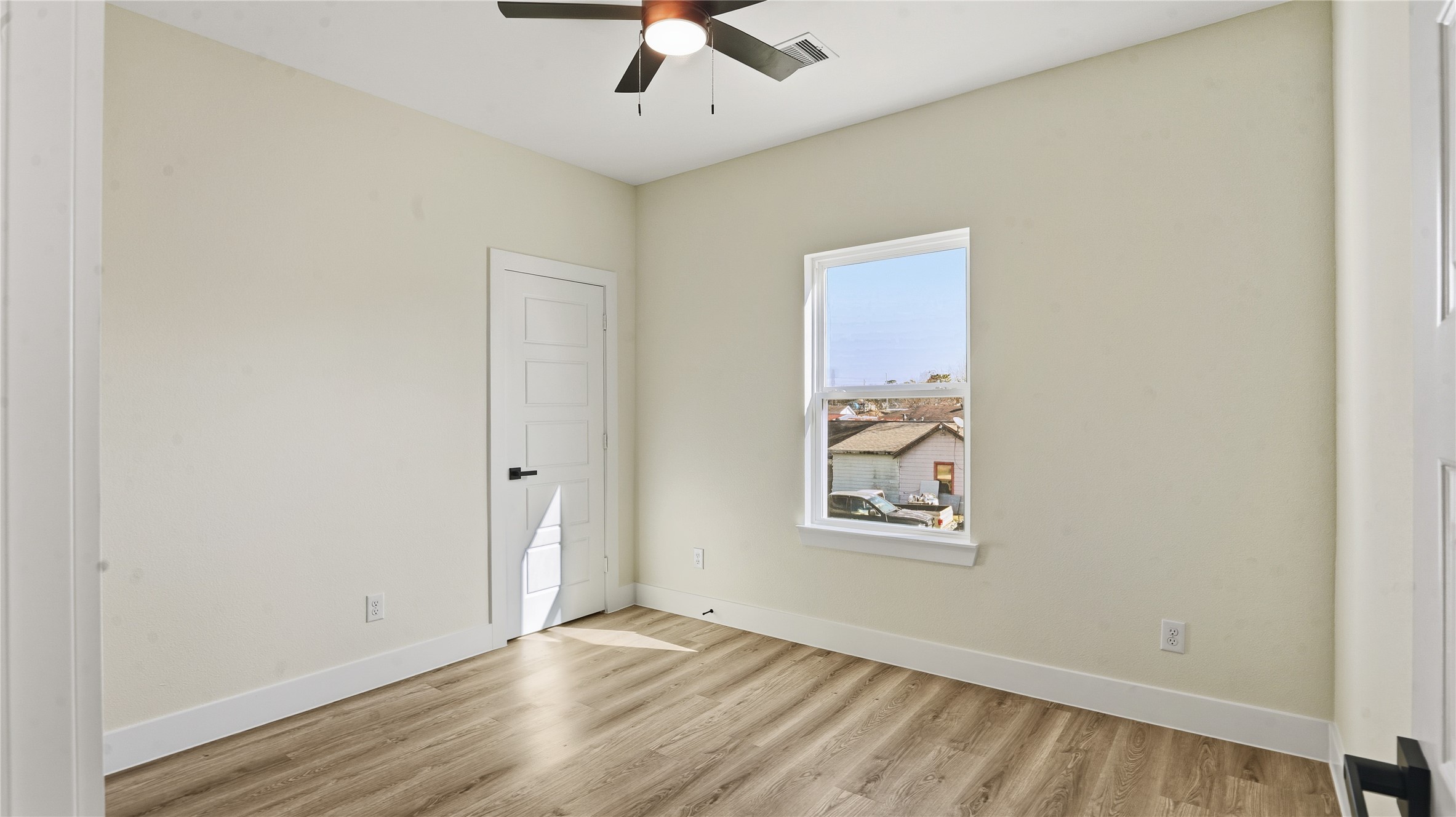 1317 Knight Street, Unit 1 Houston, TX 77022 - Photo 10 of 11 an empty room with wooden floor and windows
