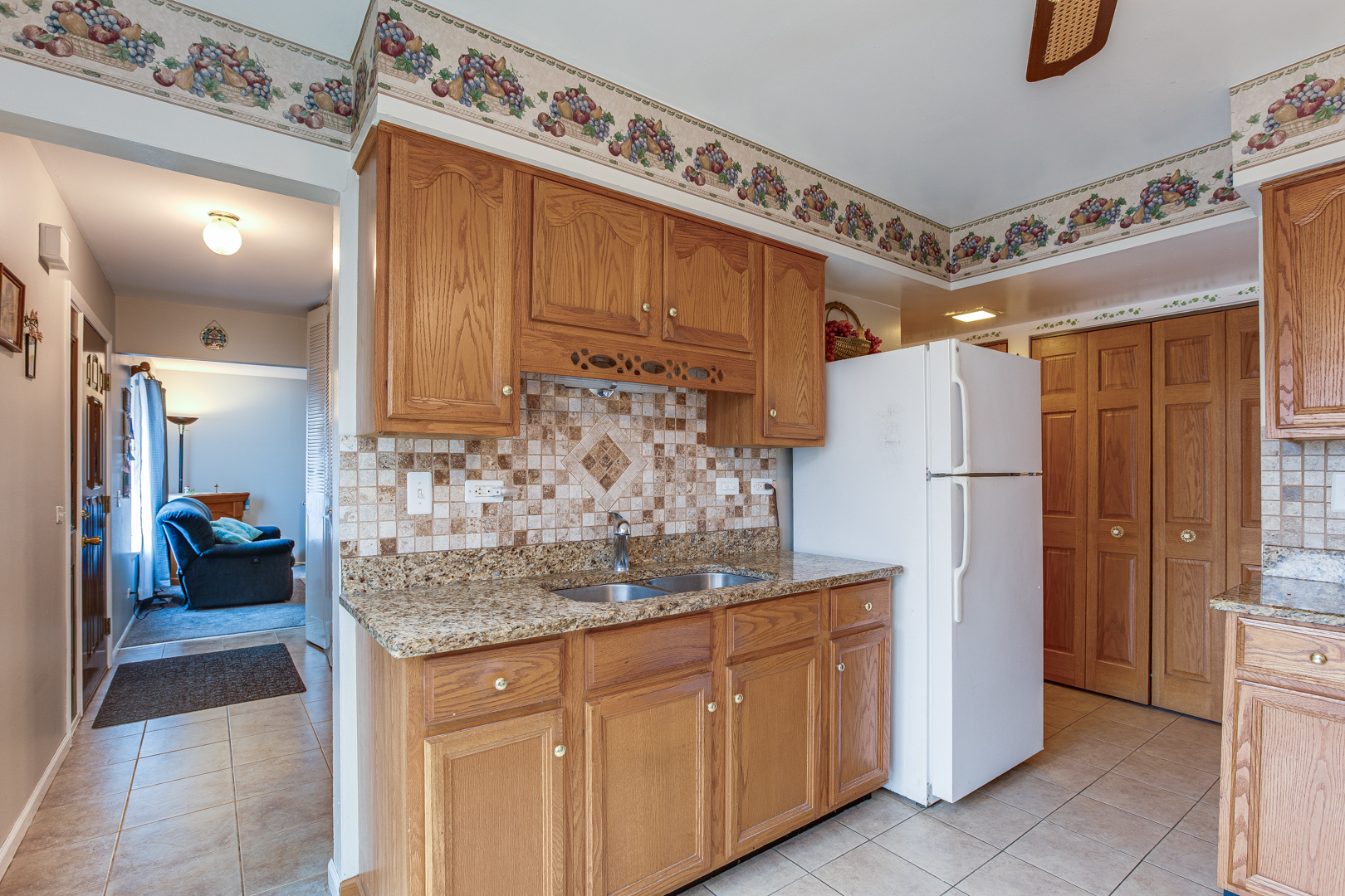 7315 Winthrop Way, Unit 6 Downers Grove, IL 60516 - Photo 5 of 11 a kitchen with refrigerator and cabinets