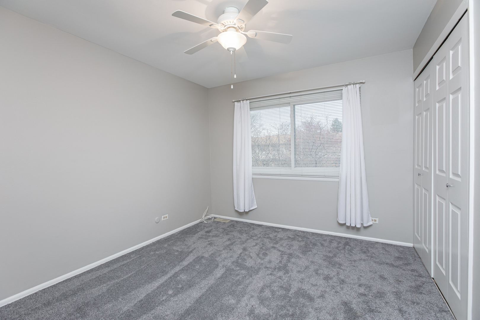 7315 Winthrop Way, Unit 6 Downers Grove, IL 60516 - Photo 10 of 11 an empty room with windows and fan