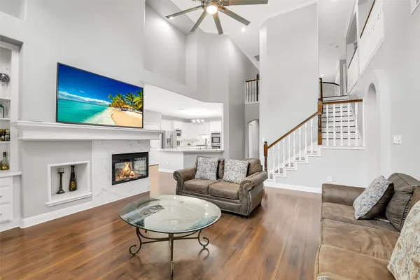 a living room with furniture a fireplace and a flat screen tv