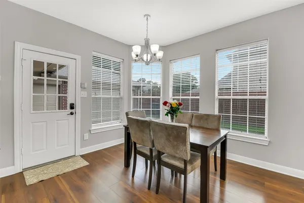 a view of a dining room with furniture window and wooden floor