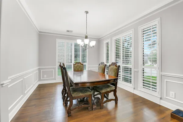 a view of a dining room with furniture window and wooden floor