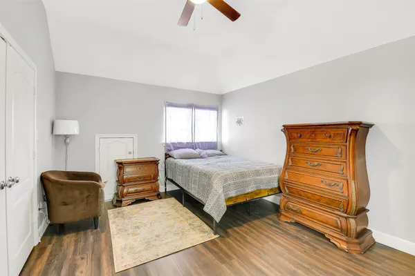 a bedroom with a bed and wooden floor