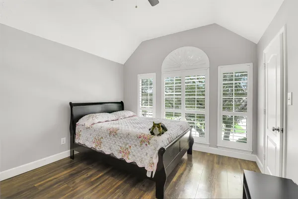 a bed sitting in a bedroom next to a window