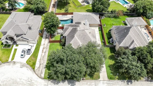an aerial view of multiple houses with yard