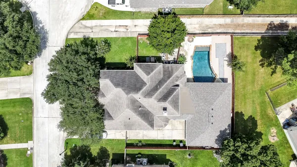 an aerial view of a house with a yard and potted plants