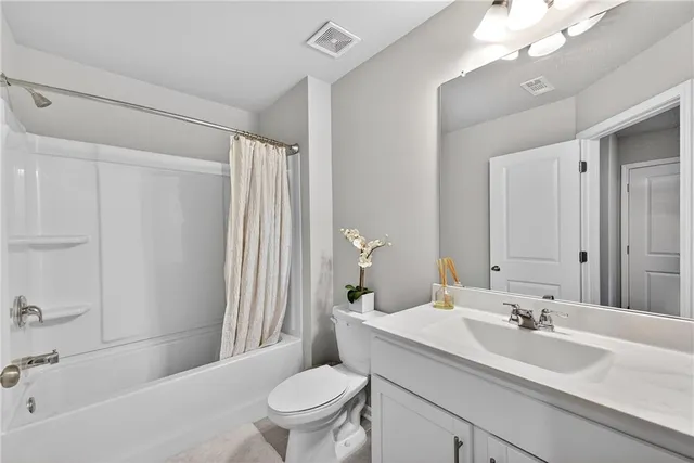 a view of a livingroom with wooden floor and a ceiling fan