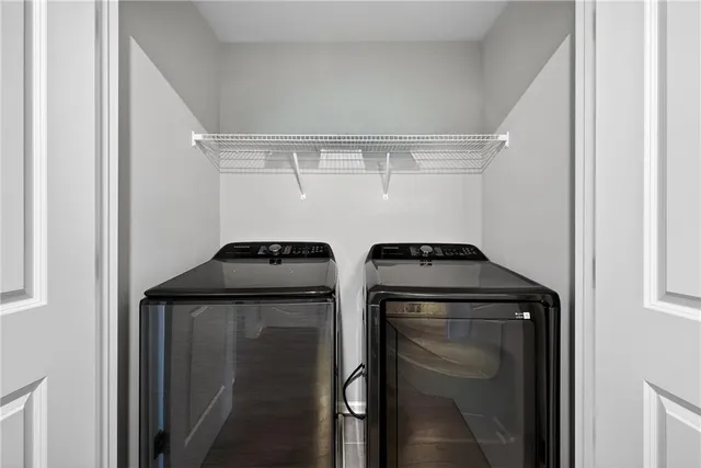 a bathroom with a double vanity sink mirror and shower