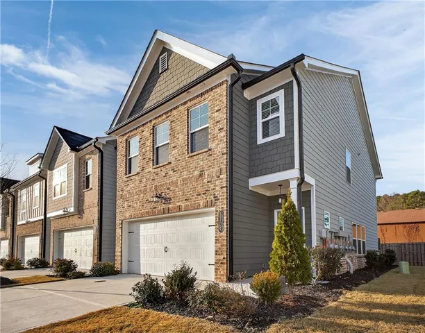 a front view of a house with a yard