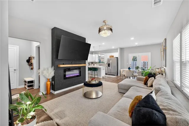 a living room with furniture a fireplace and a flat screen tv