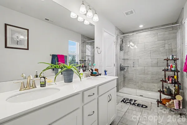 a bathroom with a sink double vanity and shower