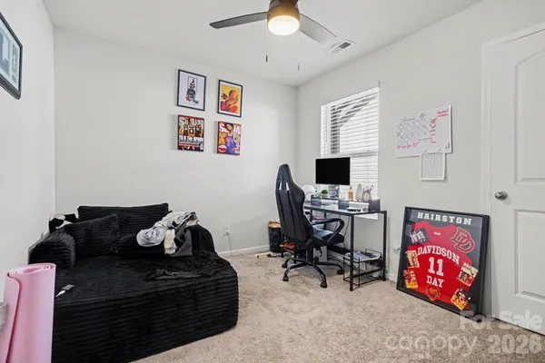 a bedroom with furniture and a flat screen tv
