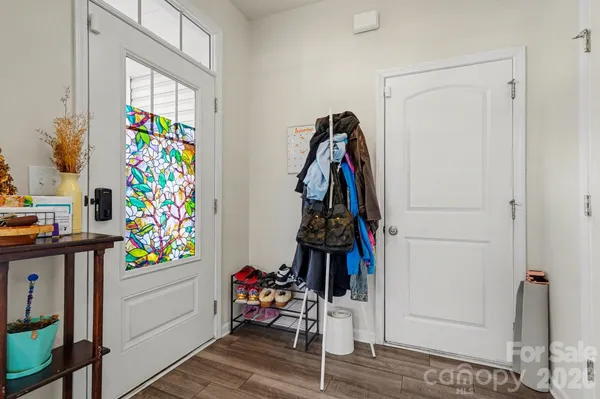 a view of kids room with toys and wooden floor
