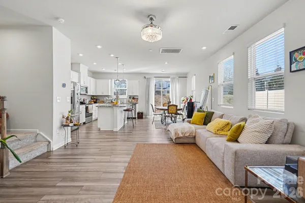 a living room with furniture and kitchen view