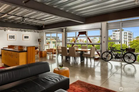 a living room with furniture fireplace and large windows